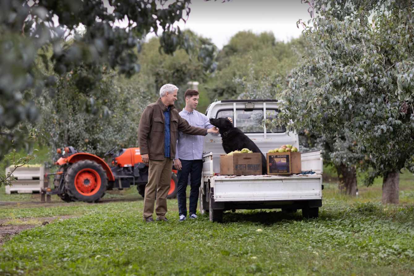 a man and a woman standing in front of a truck